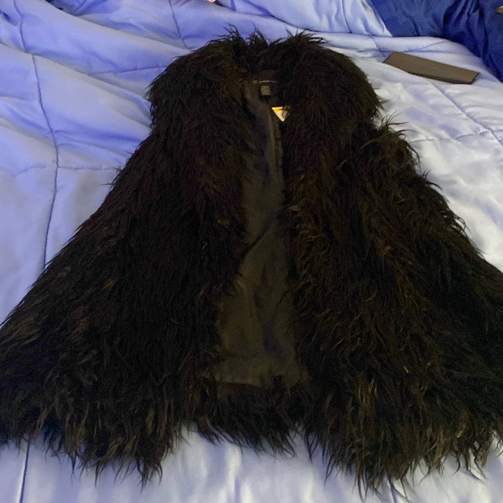 INC shag vest size medium comes to just to the middle of my buttocks in black